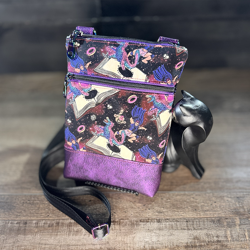 small crossbody phone bag with a cartoon of a man and a cat