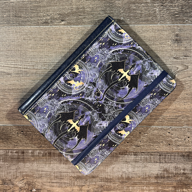 notepad holder featuring dragons in flight with a circle pattern background