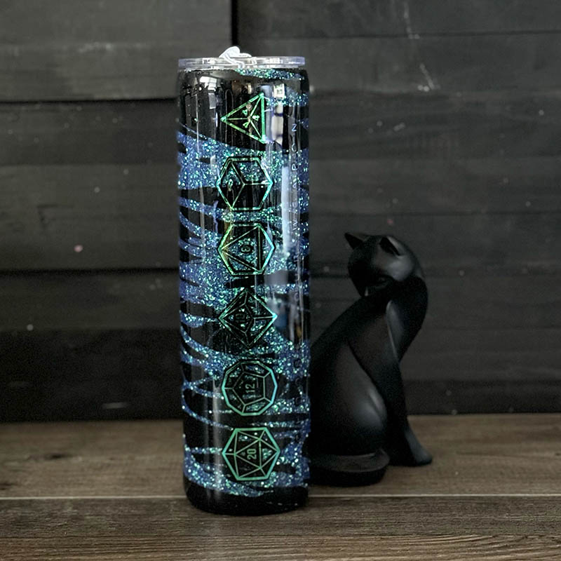 decorated 30oz steel tumbler with blue and silver ink swirls and a vinyl wing design'